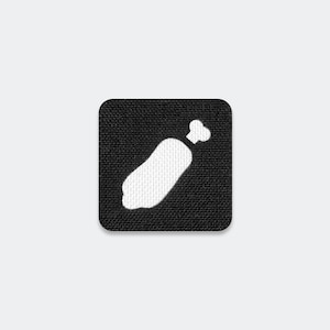 May include: A square-shaped patch with a black fabric background and a white embroidered graphic of a bone-in meat cut. The patch features rounded corners and a textured weave pattern throughout the black surface, highlighting the white icon.