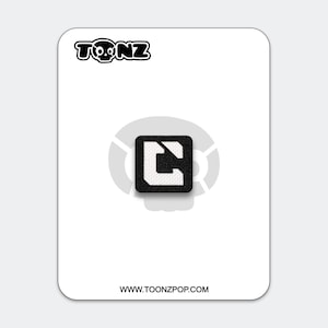 May include: A black and white patch featuring the TOONZ logo and a square design with a white "C" shape. The patch is on a white card with the website address www.toonzpop.com.