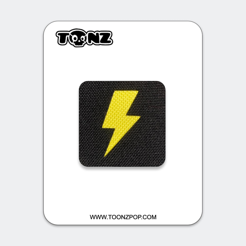 May include: A square black patch featuring a bright yellow lightning bolt icon in the center. The patch is displayed on a white backing card with the text TONZ at the top and the website URL WWW.TOONZPOP.COM printed at the bottom.