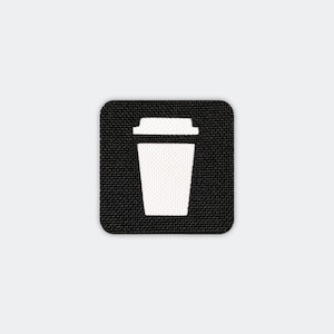 May include: A square black patch with a white coffee cup icon. The cup has a lid and is centered on the patch. The background is a textured black material, and the overall design is simple and modern.