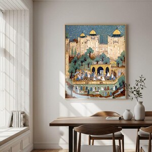 May include: A framed artwork showing a Middle Eastern palace scene with a blue sky. The artwork features a gathering of people, trees, and architectural details in gold, blue, and green. The artwork is displayed on a white wall above a wooden table in a dining room.