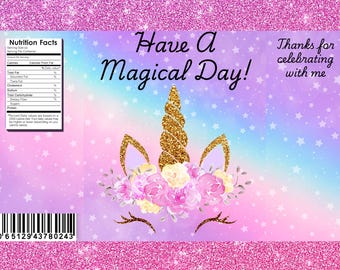 May include: A pink and purple unicorn-themed design with the text "Have A Magical Day!" and "Thanks for celebrating with me." The design includes a golden horn, ears, and floral accents. A nutrition facts label and barcode are also present.