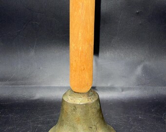 Antique brass school bell with wood handle and metal on top of handle. Marked inside on paper says” bell homers dad got me in the 50”s. 6.5”