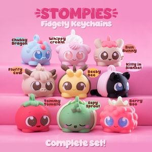May include: A complete set of Stompie Fidgety Keychains in various colours and designs. The collection includes a blue dragon, pink whipped cream, a tan bunny, a black and pink cat, a tan cow, a yellow bee, a red tomato, a green sprout, and a pink berry.