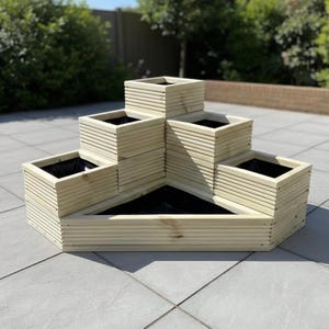 May include: A tiered wooden planter featuring a stepped, multi-level design with six distinct planting sections. The structure is constructed from light-coloured, horizontal wooden slats and includes black liners within each square and triangular compartment.