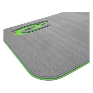 May include: A gray rectangular mat with a textured surface and a green border. The mat features a green logo in the upper left corner. The mat is designed for exercise and fitness activities.