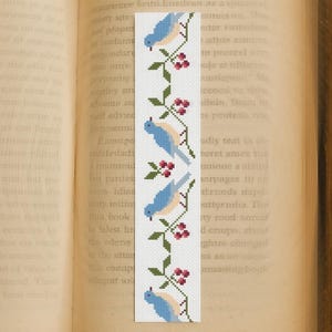 Blue birds and berries cross stitch bookmark pattern displayed on an open book, instant PDF download design