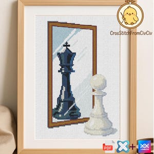 May include: Cross-stitch framed artwork featuring a chess theme. The design shows a king reflected in a mirror, with a pawn in the foreground. The king is dark blue, the pawn is white, and the frame is brown. The artwork is signed "CrossStitchFromCivCiv".