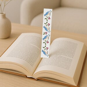 Blue birds and red berries bookmark cross stitch pattern, modern digital embroidery design shown on open book