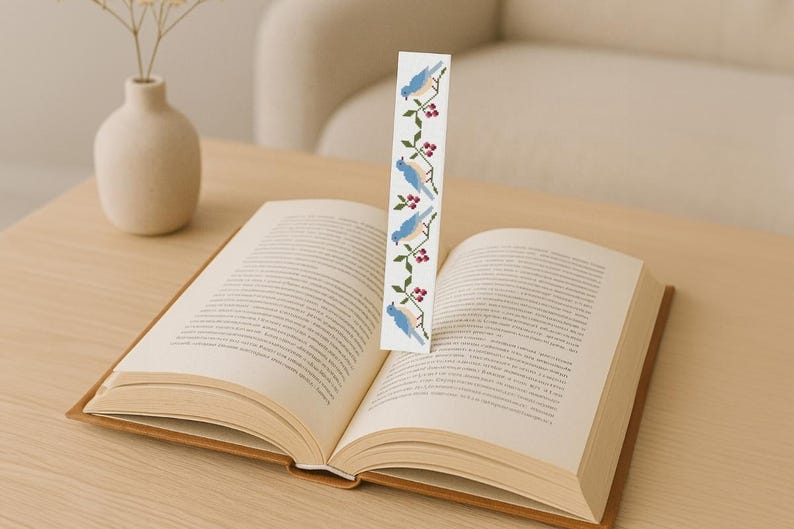 Blue birds and red berries bookmark cross stitch pattern, modern digital embroidery design shown on open book