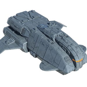 May include: A gray miniature spaceship model featuring a blocky, angular hull with intricate panel lines, side-mounted wings, and a front cockpit section with glowing orange windows. The spacecraft has a textured surface and a detailed mechanical design.