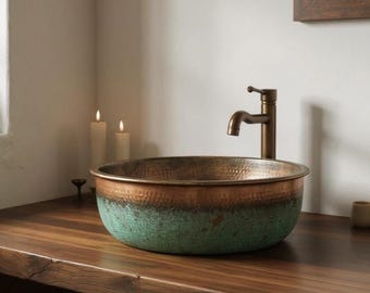 May include: A copper vessel sink with a hammered texture and a two-tone finish of brown and green. The sink is mounted on a wooden countertop with a bronze faucet. The bathroom setting includes candles and a mirror.