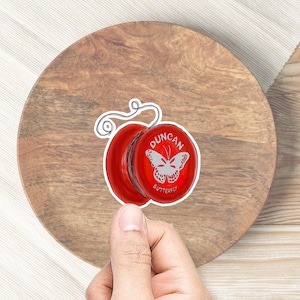 May include: Red Duncan Butterfly yo-yo with a white butterfly design and the text "Duncan Butterfly" on the side.