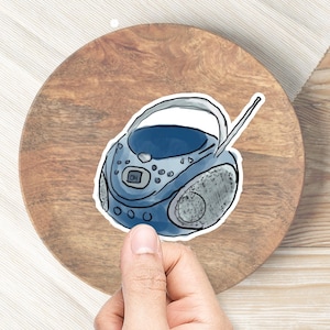 May include: A hand-drawn illustration of a portable CD player in blue and grey, with a handle and antenna.