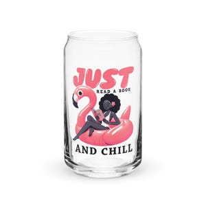May include: A clear glass can-shaped tumbler featuring a graphic of a person with dark curly hair reading a book while floating on a pink flamingo pool float. The text reads JUST READ A BOOK AND CHILL in bold pink and black lettering.
