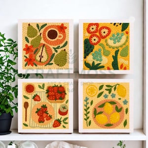 May include: Four square wall art pieces with colourful, textured designs. One features pears, flowers, and a coffee cup. Another showcases floral patterns on a yellow background. The third depicts strawberries, and the fourth displays lemons.
