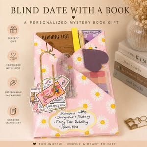 May include: A book wrapped in pink paper with a white daisy pattern, featuring a large gold paperclip, assorted stickers, a reading list, a purple heart-shaped bookmark, and a set of sticky notes. A label lists genres including romance and fantasy.