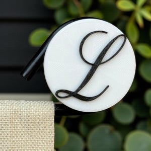 May include: A set of three ceramic mugs with a speckled, matte finish. The mugs are in shades of cream, light gray, and dark gray. Each mug has a simple, minimalist design and a rounded handle.