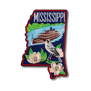 May include: Embroidered patch in the shape of Mississippi, featuring a riverboat, a bird, and magnolia flowers. The word "MISSISSIPPI" is embroidered at the top. The patch has a navy blue background with red and green accents.