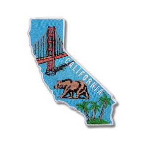 May include: Embroidered patch in the shape of California, featuring the Golden Gate Bridge in red, a brown bear, palm trees, and the word "CALIFORNIA" in white. The patch has a blue background.