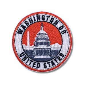 May include: Embroidered patch featuring the U.S. Capitol building and Washington Monument against a red background. The patch is round with the words "WASHINGTON DC UNITED STATES" in a white border.