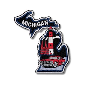 May include: Embroidered patch in the shape of the state of Michigan, with the word "Michigan" in white. The patch features a lighthouse, a red car, and a building with smokestacks, all in a blue outline.
