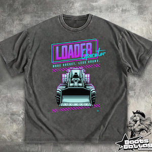 May include: Dark gray t-shirt featuring a front-facing illustration of a loader with the text "LOADER Operator" in a neon design. The shirt also includes the phrase "MORE BUCKET, LESS DRAMA."