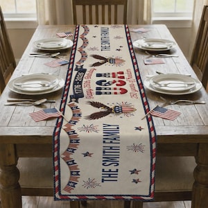 May include: A cream-coloured table runner featuring red, white, and blue patriotic graphics including eagles, fireworks, stars, and bunting. Text reads THE SMITH FAMILY, 1776-2026, Happy 250th Birthday, USA, and 250 years of freedom in red and blue.