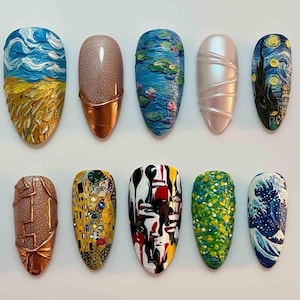 May include: A collection of ten artificial nails with various artistic designs. The designs include a textured sky and field, a copper-accented glitter nail, a water lily scene, a pearlescent nail, and a starry night scene.