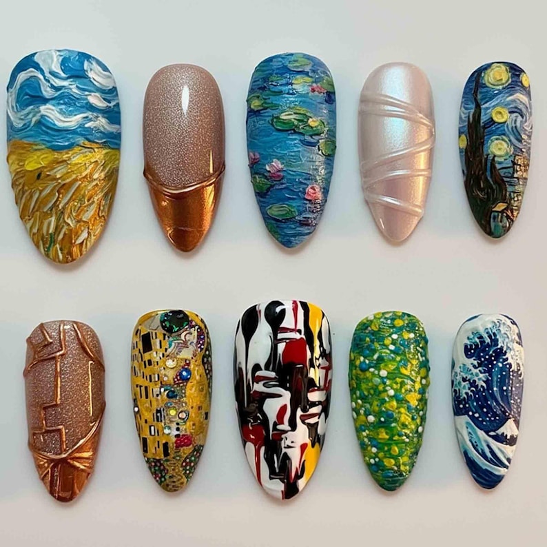 May include: A collection of ten artificial nails with various artistic designs. The designs include a textured sky and field, a copper-accented glitter nail, a water lily scene, a pearlescent nail, and a starry night scene.