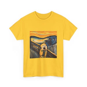 May include: A yellow t-shirt with a parody of Edvard Munch's "The Scream" artwork. The design shows a cartoon character in the style of the original painting, with a shocked expression against a swirling blue and orange background.