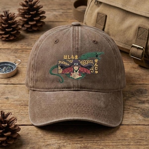 May include: A white ceramic mug with a black handle and the text "But First, Coffee" in a bold, black font. The mug is sitting on a wooden surface. The mug appears to be 12 ounces.