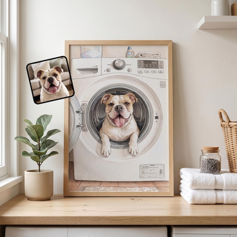 May include: A framed wall art print featuring a white and tan bulldog with its head and front paws poking out of the open door of a white washing machine. A smaller inset photo of the same bulldog is positioned in the upper left corner.