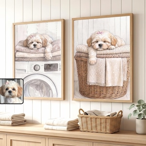 May include: Two framed wall art prints featuring a light-colored puppy sleeping on laundry. The left print shows the puppy on a washing machine, and the right print shows the puppy in a wicker basket. A small inset image shows the puppy's face.