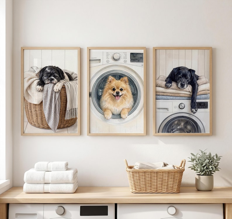 May include: Three framed wall art prints featuring dogs in a laundry room. The left print shows a black and white dog in a wicker basket. The center print shows a tan Pomeranian inside a washing machine. The right print shows a black dog on a dryer.