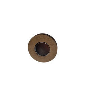 May include: A round, brown magnet with a silver center. The magnet is made of wood and metal. The magnet is a simple, yet functional item.