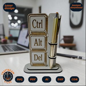 May include: A wooden desk organizer with a keyboard key design. The organizer features the words "Ctrl", "Alt", and "Del" engraved on the front. A gold pen is placed in the holder. The design includes the text "Laser design" and "Instant download".