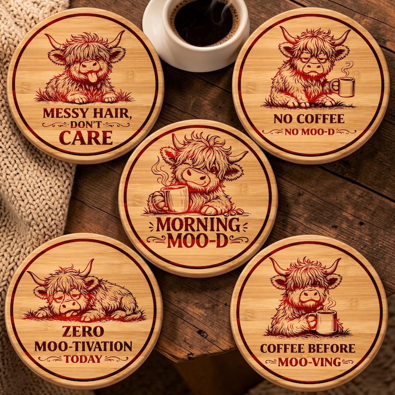 May include: Five round bamboo coasters featuring illustrations of Highland cattle. Each coaster displays a unique cow graphic and text: Messy Hair, Don't Care; No Coffee No Moo-d; Morning Moo-d; Zero Moo-tivation Today; and Coffee Before Moo-ving.