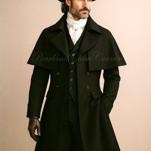 May include: A black overcoat with a cape, worn over a vest and trousers. The outfit includes a black hat, white scarf, and brown gloves. The text "Pearland Glam Corner" is visible on the coat.