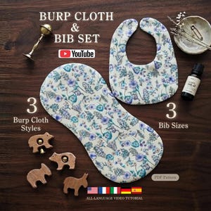 May include: A burp cloth and bib set featuring a floral pattern in shades of blue, purple, and green on a cream background. The set includes text reading BURP CLOTH & BIB SET, 3 Burp Cloth Styles, 3 Bib Sizes, and PDF Pattern.