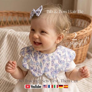 Op de afbeelding: Een lachende baby draagt een bloemen slabbetje en een bijpassende haarstrik. De slab en strik hebben een blauw-wit bloemenpatroon. De tekst op de afbeelding luidt "Bib & Bow Hair Tie" en "2 Sizes". Het YouTube-logo is ook zichtbaar.