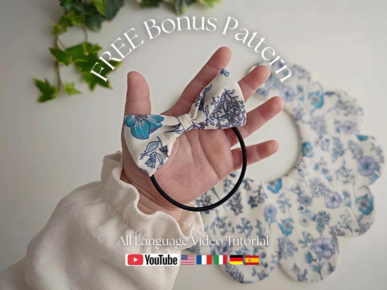 May include: A white and blue floral bow hair tie held in a hand, with a matching bib in the background. The image includes the text "FREE Bonus Pattern" and "All Language Video Tutorial" with a YouTube logo.