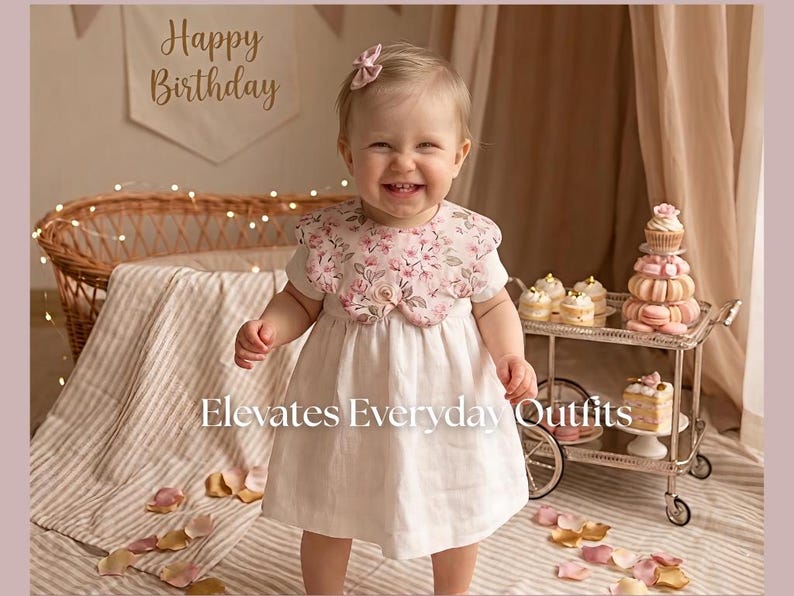 May include: A smiling child wearing a white dress with a floral collar and a matching bow. The image includes text that reads "Happy Birthday" and "Elevates Everyday Outfits". A decorative cart with desserts is in the background.