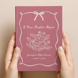 May include: A mauve-colored book with the text "A New Chapter Begins" and "Jennifer's Baby Shower" in a script font. The cover features a white floral and book illustration with a bow at the top. The date "January 15, 202X" is also included.