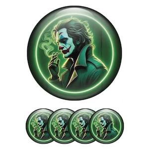 May include: A set of six round buttons featuring a portrait of a character with white face paint, red lips, and green hair, smoking a cigarette. The character is set against a green neon circle. The buttons are green, black, white, and red.