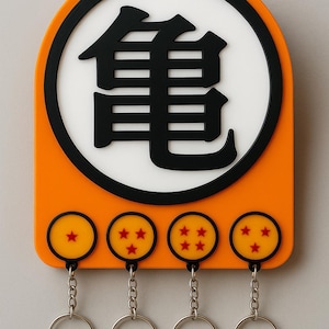 May include: Orange key holder with a black and white design featuring a Japanese symbol and four yellow circles with red stars. Each circle has a silver key ring attached.