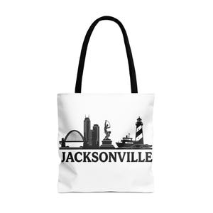 May include: White tote bag with black handles featuring a black and white skyline design. The design includes a bridge, buildings, a statue, a lighthouse, and the word "JACKSONVILLE" in bold letters.