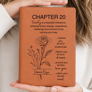 May include: A brown leather journal with the text "CHAPTER 20" and a floral design. The journal includes the text "Twenty is a beautiful milestone, embrace every change, experience, challenge and moment of joy coming your way." The name "Dianne Eliza" is also visible.