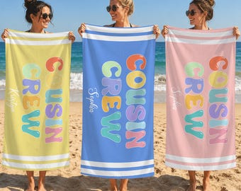 May include: Three rectangular beach towels in yellow, blue, and pink, each featuring the text COUSIN CREW in colorful bubble letters and a personalized name printed vertically on the side, with white horizontal stripes at the top and bottom edges.