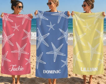 May include: Three rectangular beach towels in coral, blue, and yellow, each featuring a white starfish pattern. The coral towel is personalized with the name Jackie, the blue towel with Dominic, and the yellow towel with the name LILLIAN.